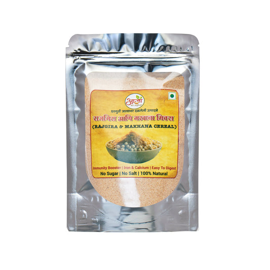 A silver pouch of Rajgira & Makhana Mix features a label with a bowl of this protein-rich breakfast, highlighting benefits like no sugar, no salt, 100% natural ingredients, iron, calcium, and easy digestion. -  Rajgira & Makhana Mix - My Store