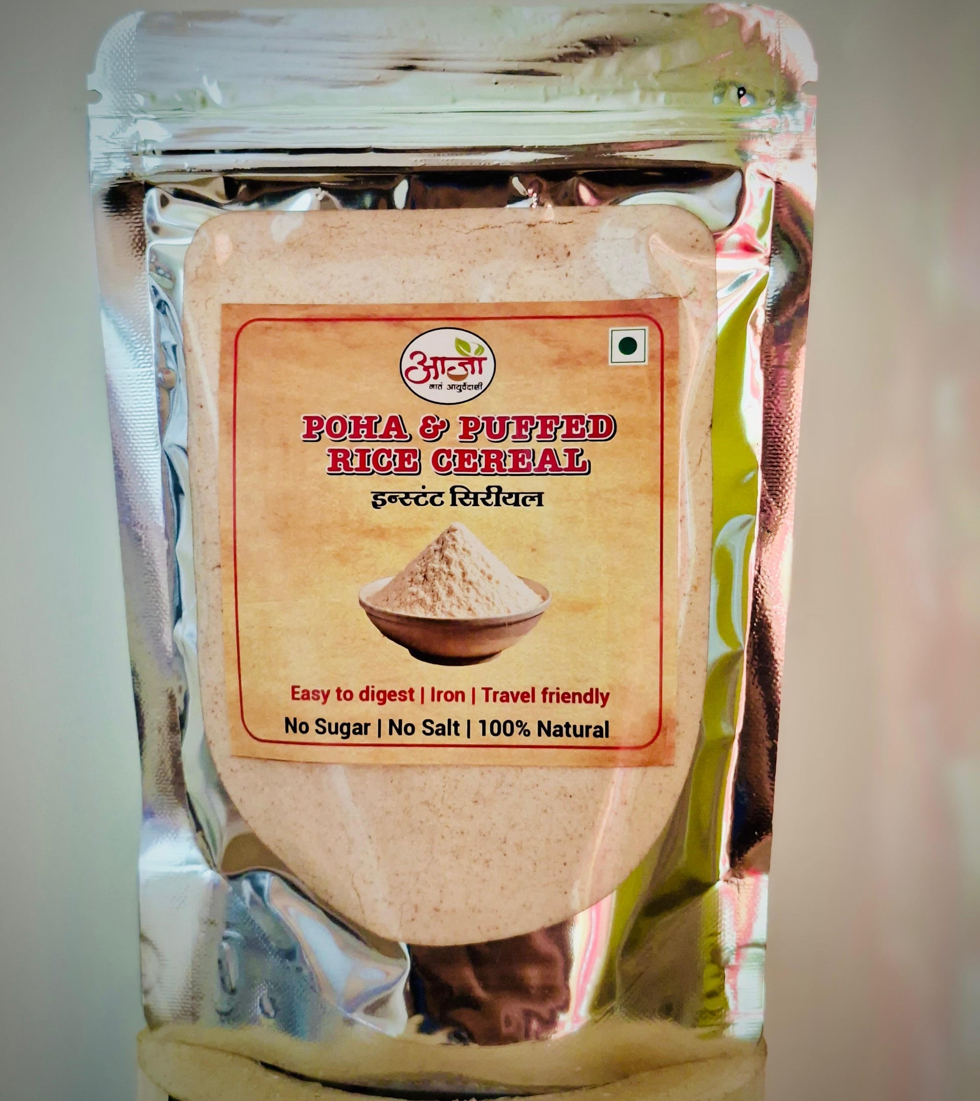 A silver packet labeled Poha & Puffed Rice Cereal - Instant Cereal shows a pile of powdered cereal. This 100% natural baby cereal is iron-rich, easy to digest, travel friendly, and contains no added sugar or salt—ideal for breakfast.